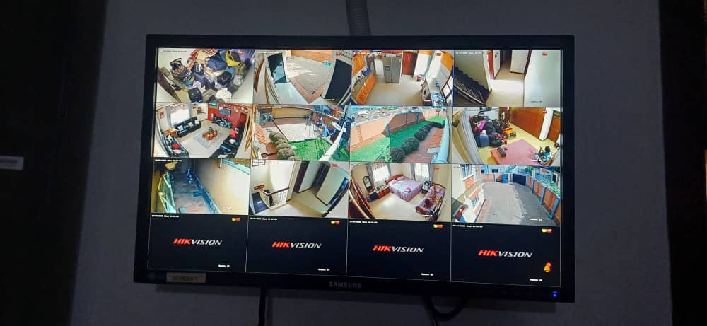Hikvision 12-channel live monitoring screen showing all security camera feeds